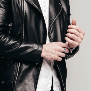 Men's stainless steel ring with black spider pattern, punk style on model in leather jacket