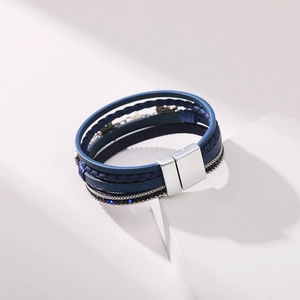Detail view of the silver magnetic clasp and multilayer navy leather wrap bracelet textures