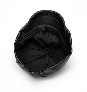 Detail view of the plush lining and elastic adjuster inside the leather newsboy cap