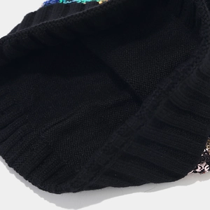 Detailed close-up showing the dense inner knit and colorful sequins of this black beanie