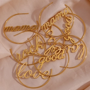 Detailed view of gold-plated hoop earrings with carved mama rock and love text