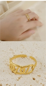 Macro shot of 18K gold plated hollow chain ring on stone texture with close-up detail