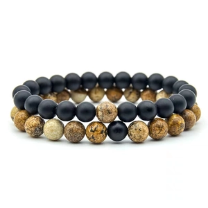 Detailed macro view of 8mm natural lava rock and tiger eye stone beaded stretch bracelets