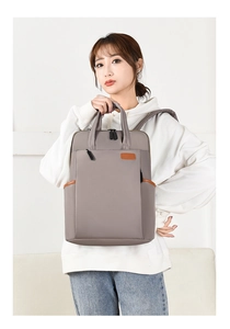 Detail view of the taupe multi-functional backpack with durable nylon fabric and side pockets