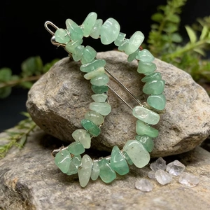 Detailed view of natural green crystal chips on a moon-shaped hair clip for women