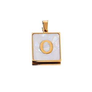 Macro shot of 22mm square shell pendant with gold letter O and stainless steel frame
