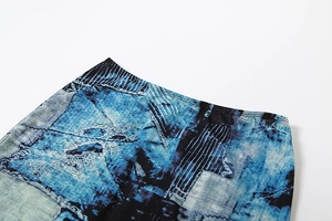 Detail of high-waist skirt featuring blue abstract tie-dye print and precise stitching