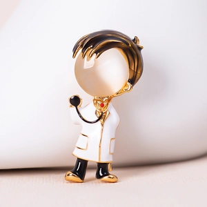 Macro shot of a cartoon doctor brooch with opal head and detailed enamel medical coat