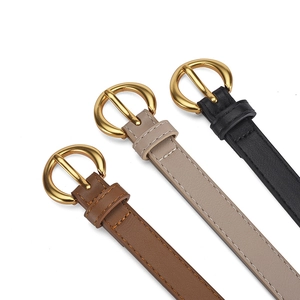 Three minimalist women leather belts in brown, beige and black with round gold buckles