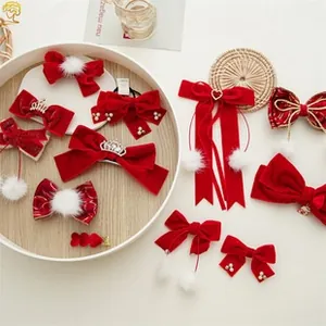 Detailed set of red velvet hair bows with pearls, fur balls, and festive embellishments