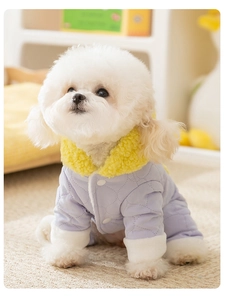 Detail view of the soft yellow faux fur collar and quilted lavender fabric on dog winter coat
