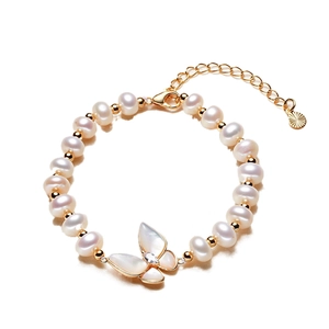Elegant freshwater pearl bracelet with a golden butterfly shell pendant on white background