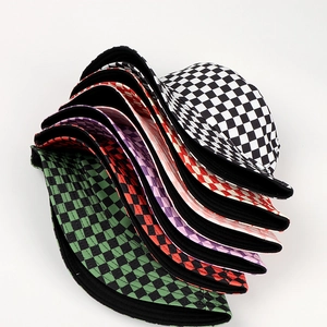 Detailed stack of multi-colored checkerboard reversible bucket hats in various shades