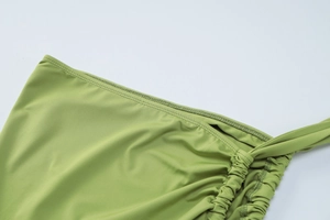 Detailed close-up of adjustable side drawstring and ruched texture on lime green skirt