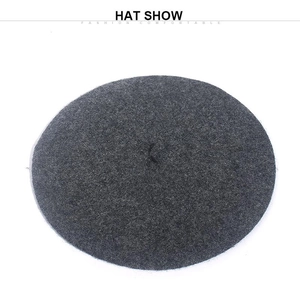 Overhead view of a dark gray wool beret showing smooth texture and round silhouette