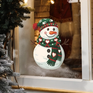 Detail of a cute snowman window cling sticker with a red-green hat on glass