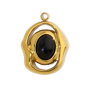 Macro shot of French vintage gold pendant featuring an oval black stone in lava frame