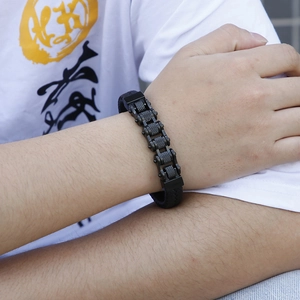 Close-up of black bicycle chain style stainless steel men's bracelet on wrist