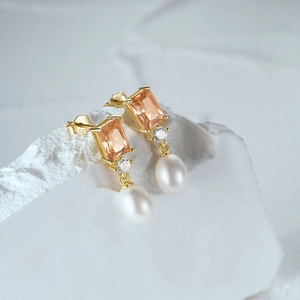 Detail of S925 silver earrings featuring champagne gemstones and teardrop pearls