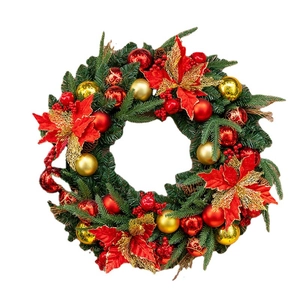 Lush red and gold Christmas wreath with poinsettias, pine needles and festive ornaments