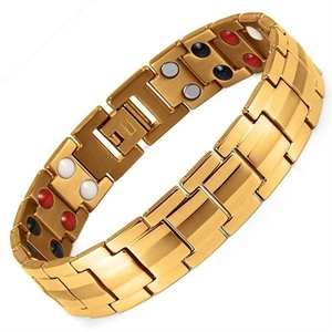 Close-up of magnetic bracelet inner link with four-color energy stones and golden finish