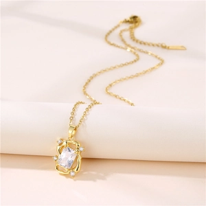 Elegant gold chain necklace with a rectangular zircon pendant in a twisted metal frame