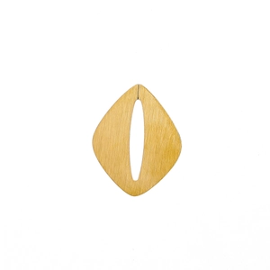 Detail of a diamond-shaped golden pendant with a premium brushed metal texture finish