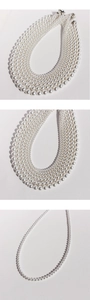 Vertical view of layered white pearl necklaces showing lustrous texture and silver clasp
