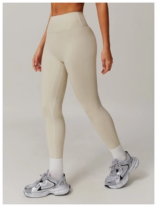 Detail view of high-waist yoga pants showing the seamless stitching and matte fabric texture