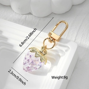 Detail shot of purple translucent strawberry charm with dimensions 6.8x2.3cm and gold hook
