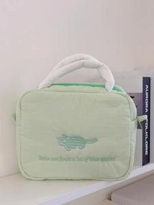 Quilted light green makeup bag with cat embroidery and soft white handles for travel