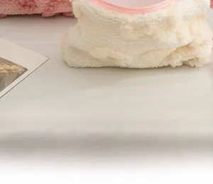 Close-up of cream fleece makeup bag with pink zipper and soft textured sherpa fabric