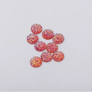 Macro detail of 12mm red resin druzy flatback beads with sparkling glitter for DIY jewelry