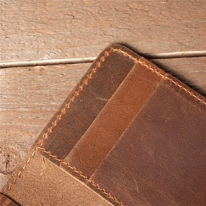 Close-up of vintage brown crazy horse leather card holder with detailed stitching