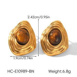 Detail view of gold vintage wavy earrings with tiger eye stone including size specifications