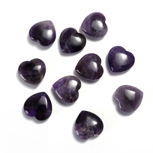 Close-up of nine polished heart-shaped amethyst gemstones with natural purple textures