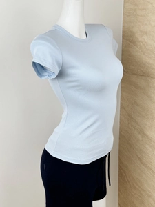 Close-up of light blue ribbed knit t-shirt with a slim fit and classic crew neck