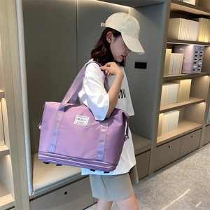 Large purple travel bag with wheels, waterproof material and expandable storage design