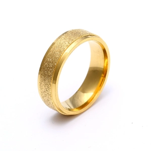 Detail of 6mm gold titanium ring with a matte frosted center and polished beveled edges