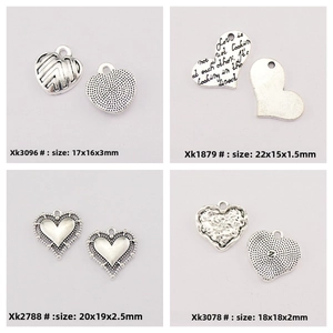 Detailed views of four distinct heart-shaped silver alloy pendants with size measurements