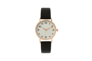 Macro view of white watch dial with Arabic numerals and rose gold case on black strap