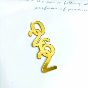Detail of gold mirror acrylic love lettering for Christmas cake decoration