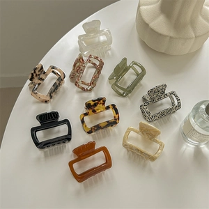Colorful acetate leopard square hair claws in various shades on a white surface
