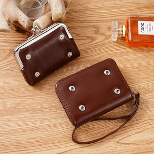 Retro dark brown PU leather coin purses with metal clasp and rivet details on wood