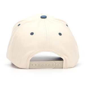 Detail view of the beige cotton twill baseball cap with adjustable blue snapback closure