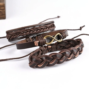 Three-piece brown leather braided bracelet set with bronze infinity symbol on white background