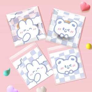 Detail of transparent self-adhesive snack bags with blue checkerboard and cute animal prints