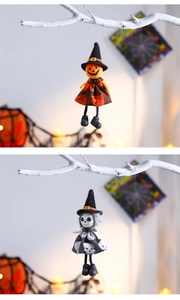 Detail of Halloween hanging dolls featuring pumpkin and skeleton heads with witch hats