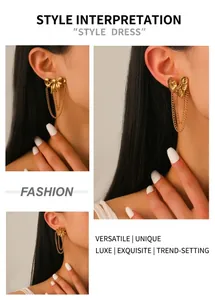 Detailed view of gold tassel earrings with bow, heart, and flower motifs on ear
