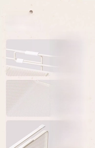 Detail of adjustable metal kitchen basket showing safety caps and mesh grid texture